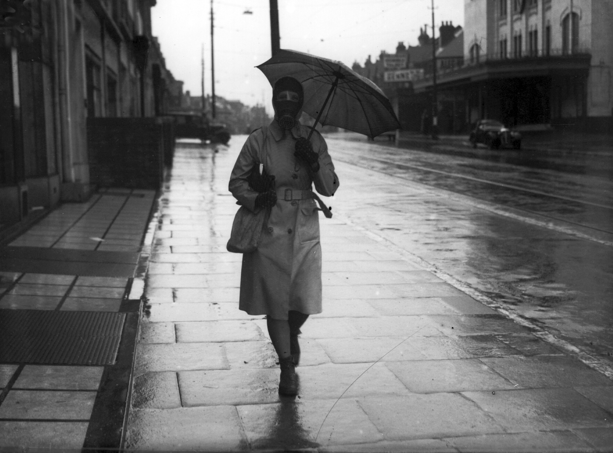 Civilians go out in the rain during the gas mask drill in April 1941. THE SOUTHERN DAILY ECHO ARCHIVES. HAMPSHIRE HERITAGE SUPPLEMENT. Ref: 135z