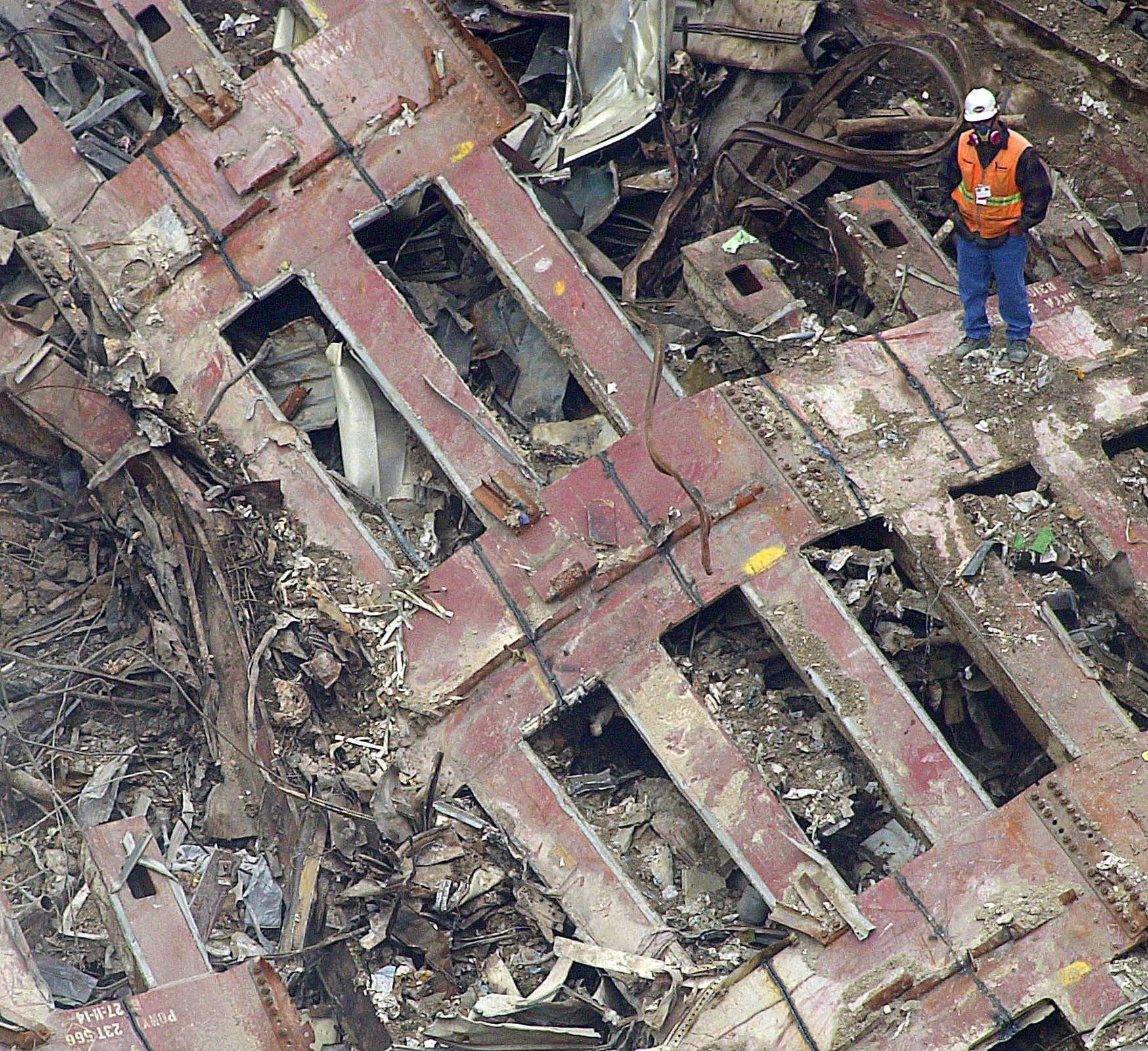 A rescue worker stands on a piece of steel where the World Trade Center once stood in New York, Thursday, Sept. 27, 2001. (AP Photo/Ed Betz) (JM DM).