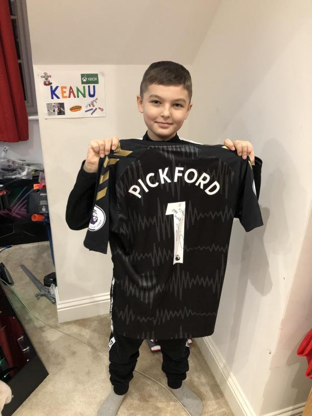 Daily Echo: Keanu Black holding a shirt donated by Everton goalkeeper Jordan Pickford.