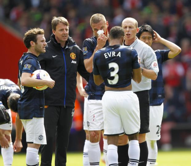 Daily Echo: A bloodied Vidic argues with Mike Dean. Image by: PA