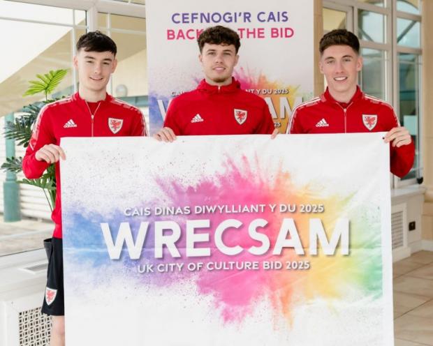 Daily Echo: Dylan Levitt, Neco Williams and Harry Wilson - all from North Wales - with the Wrecsam 2025 flag.
