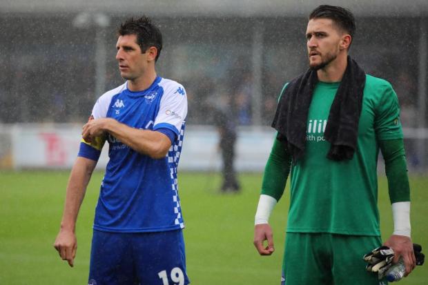 Eastleigh goalkeeper Joe McDonnell with Danny Hollands (Picture: Tom Mulholland)