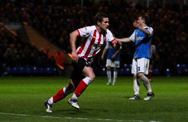 Daily Echo: Sharp wheels away after scoring his side's third goal at Peterborough. Image by: PA