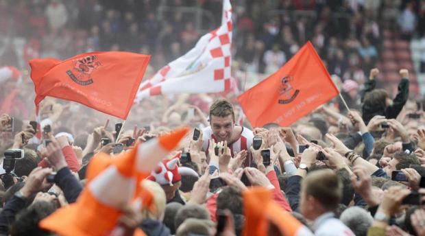 Daily Echo: Lambert is mobbed on by Saints fans after securing promotion to the Premier League.