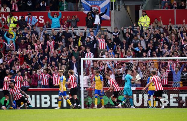 Daily Echo: Brentford celebrate scoring against Saints in May. Image by: [A