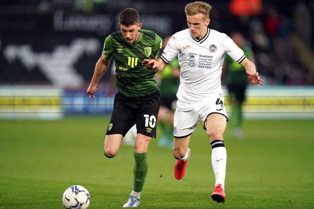 Bournemouth's Ryan Christie (left) and Swansea City's Flynn Downes battle for the ball during the Sky Bet Championship match at the Swansea.com Stadium, Swansea. Picture date: Tuesday April 26, 2022. PA Photo. See PA story SOCCER Swansea. Photo