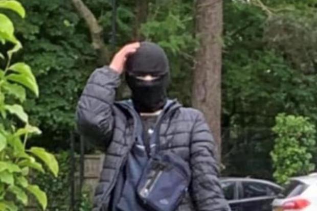 An image shared by Redbridge Community College of a person in a balaclava who is said to have threatened a pupil.
