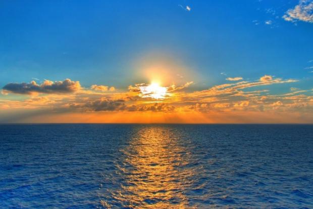 Daily Echo: The sun setting over the sea. Credit: Canva