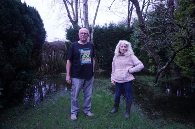 Felicity and Stephen Thompson from Eastleigh fear for their garden after it was submerged in 'four feet of water'
