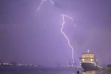 Night sky near cruise ship Queen Anne lit up by lightning strike
