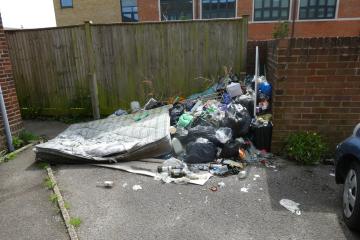 Fly-tipping outside Freemantle United Reformed Church as cars move on