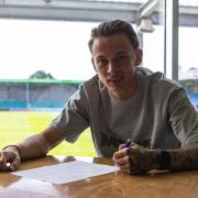 Eastleigh FC’s Ryan Hill signs a new contract at the Silverlake Stadium (Pic: Eastleigh FC / Tom Mulholland)