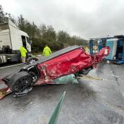 Crash involving two cars and a car transporter on M3