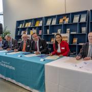 Politicians and university leaders sign the new agreement