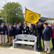 Members of the Royal Hampshire Regiment Comrades' Association unveil the memorial bench