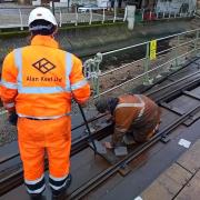 Final checks are carried out on the new section of track that has been laid at the shore end of Hythe Pier