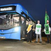 The First Bus Solent team with Spinnaker Tower in Portsmouth lit up green to mark the arrival of the buses