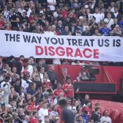 Manchester United fans display a banner in protest in the stands (Peter Byrne/PA)