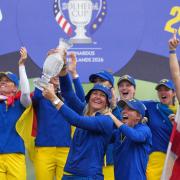 Anna Nordqvist holds the trophy aloft after her team won the Solheim Cup (Alastair Grant/AP)