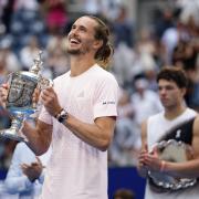 Alexander Zverev, of Germany, left, poses with the trophy after he won the men’s singles final of the U.S. Open tennis championships against Ben Shelton, of the United States, Sunday, Sept. 13, 2026, in New York. (AP Photo/Adam Hunger)