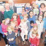 Campaigners at Cobbett Road Library hand over their 500-name petition on Saturday.