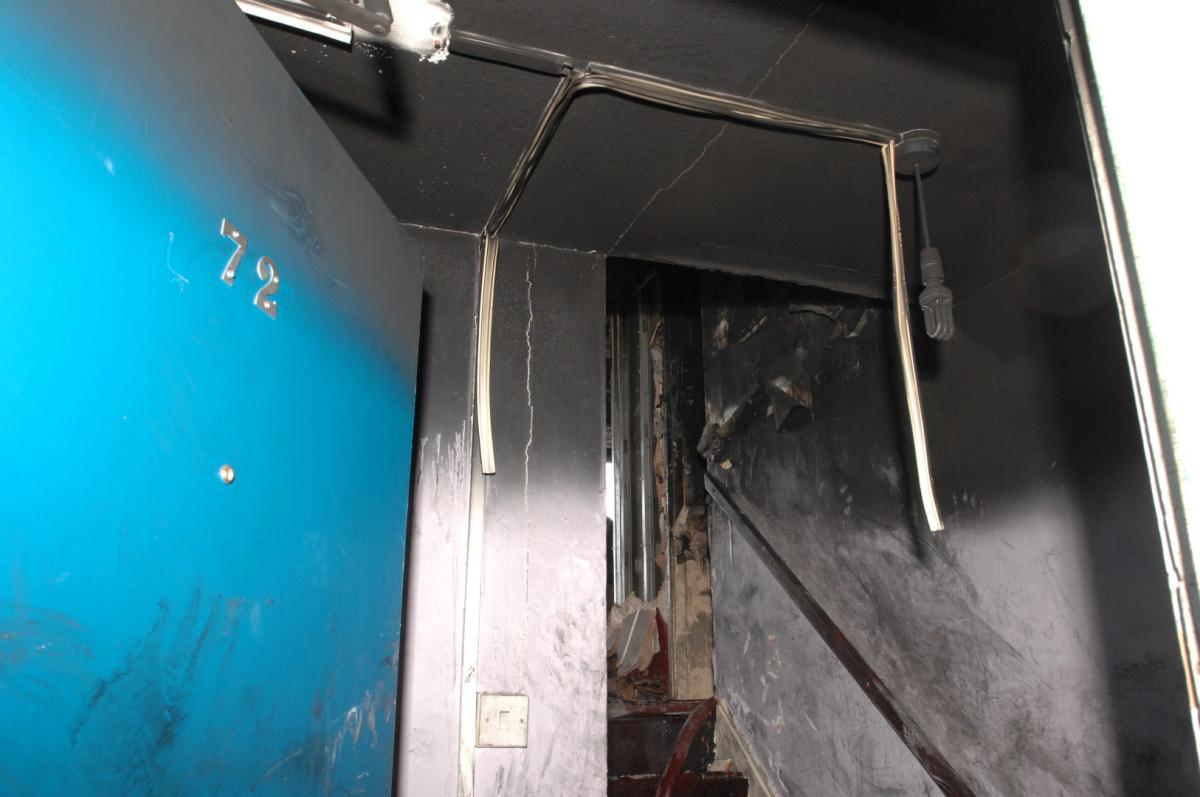 A view from the front door of Flat 72, looking up the stairs towards the lounge where the fire broke out.