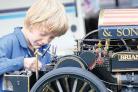 Young Drew Cleal polishes his mini traction engine.