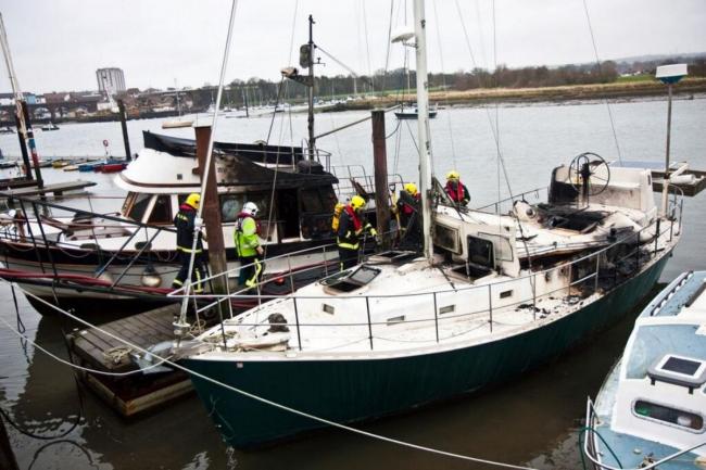 Firefighters investigate the boats following the blaze