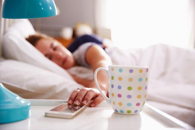 A generic photo of a woman turning off her smartphone alarm clock. See PA Feature TOPICAL Wellbeing Apps. Picture credit should read: PA Photo/thinkstockphotos. WARNING: This picture must only be used to accompany PA Feature TOPICAL Wellbeing Apps